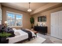 Main bedroom with a large bed, dresser, and plenty of natural light at 12912 Ironstone Way # 101, Parker, CO 80134