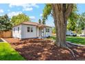 Attractive home with a mature tree and a nicely landscaped front yard at 4465 N Umatilla St, Denver, CO 80211