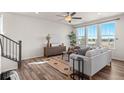Bright living room featuring hardwood floors, large windows with lots of natural light, a ceiling fan, and stylish furniture at 455 N Old Hammer St, Aurora, CO 80018