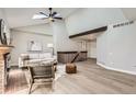 Inviting living room with vaulted ceiling, wood beam, and open staircase at 19383 E Chaffee Pl, Denver, CO 80249