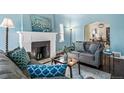 Cozy living room with blue walls, fireplace, and comfortable seating arrangements at 3083 Ash St, Denver, CO 80207