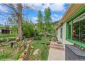 View of a private and well-maintained backyard with beautiful landscaping and a small playhouse at 3384 Avenue F, Kittredge, CO 80457