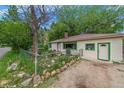 Cozy home exterior with a rock-lined garden and a well-manicured lawn at 3384 Avenue F, Kittredge, CO 80457