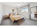 Cozy bedroom features a comfortable bed, ample natural light, and tasteful decor at 9400 E Iliff Ave # 145, Denver, CO 80231