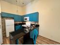 Bright kitchen featuring modern blue cabinets, tiled backsplash, and sleek countertops at 909 S Dawson Way # 19, Aurora, CO 80012