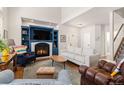 Inviting living room with a cozy fireplace, vaulted ceilings, and a staircase leading to the upper level at 4739 Raven Run, Broomfield, CO 80023