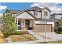Inviting two-story home featuring landscaping and an attached two-car garage at 10788 Ventura St, Commerce City, CO 80022