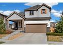 Inviting two-story home featuring manicured landscaping and an attached two-car garage at 10788 Ventura St, Commerce City, CO 80022