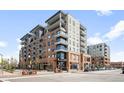 Modern condo building with brick facade, balconies, and street-level retail spaces at 20 Wilcox St # 314, Castle Rock, CO 80104