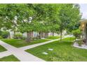 Exterior view showcasing the well-maintained lawn and walkway leading to the home at 1250 S Monaco Street Pkwy # 49, Denver, CO 80224