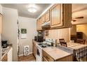 Functional kitchen with ample cabinet space, appliances, and an adjacent dining area at 1250 S Monaco Street Pkwy # 49, Denver, CO 80224