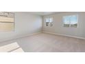 Spacious bedroom with large windows and neutral carpeting at 48260 Shetland Dr, Bennett, CO 80102