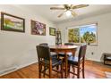 Dining area with hardwood floors and a table for four at 6618 S Newland Cir, Littleton, CO 80123