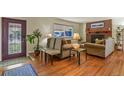 Living room features hardwood floors, fireplace, and lots of natural light at 6618 S Newland Cir, Littleton, CO 80123