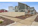 A modern home with neutral siding and a wood fence, surrounded by rock landscaping, offering privacy and style at 4138 N Quatar Ct, Aurora, CO 80019