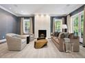 Cozy living room with fireplace, plush seating, and natural light filtering through the windows at 450 Steele St, Denver, CO 80206