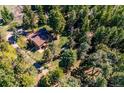 Aerial view of a secluded home nestled within a dense forest at 25357 Snyder Ave, Conifer, CO 80433