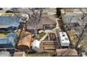 Aerial view of fenced backyard with a shed, raised garden beds, firepit, and RV parking at 4713 Cody St, Wheat Ridge, CO 80033