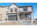 Two-story house with gray siding, red shutters, and a gray three-car garage at 18344 Prince Hill Cir, Parker, CO 80134