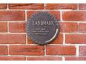 Close-up of landmark plaque on brick exterior wall, celebrating local Denver County and city historical preservation at 2914 W 29Th Ave, Denver, CO 80211