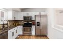 Modern kitchen featuring stainless steel appliances and granite countertops at 11082 Callaway Rd, Parker, CO 80138
