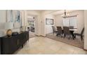 Inviting entryway with tile flooring, stylish console table, and seamless flow into the dining and living areas at 10273 Nottingham Dr, Parker, CO 80134