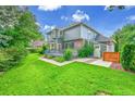 Beautiful backyard featuring a well-maintained lawn, a deck perfect for entertaining, and mature trees at 1321 Ruby Way, Longmont, CO 80504