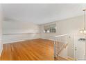 Bright living room featuring hardwood floors and stairway access to upper level at 6721 Quay Ct, Arvada, CO 80003