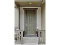 Charming front porch with a neutral-colored front door, plants and comfortable seating at 4280 Pioneer Pl, Brighton, CO 80601