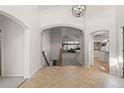 Open-concept living with archways leading to the kitchen and living room at 47 Herrn Ln, Castle Pines, CO 80108