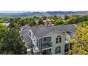 Charming multi-level home with mountain views, balconies, and arched windows surrounded by trees at 1670 S Deframe St # C2, Lakewood, CO 80228