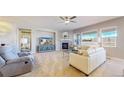 Bright living room with a fireplace, ceiling fan, and an abundance of natural light at 11829 Deorio St, Parker, CO 80134