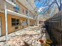 The inviting courtyard features multiple levels of apartments and a seating area at 1135 N Elizabeth St # 102, Denver, CO 80206