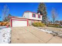 Two-story house with white siding, red accents, and a driveway at 17009 E Loyola Pl, Aurora, CO 80013