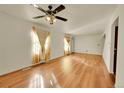 Bright living room featuring hardwood floors and a ceiling fan at 17009 E Loyola Pl, Aurora, CO 80013