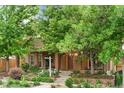 Well-maintained brick home with lush front yard landscaping and mature trees at 4511 Perry St, Denver, CO 80212