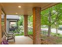 Inviting covered front porch with brick pillars and seating area at 4511 Perry St, Denver, CO 80212