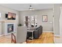 Cozy living room featuring a tiled fireplace, hardwood floors, and ample natural light at 4511 Perry St, Denver, CO 80212