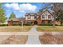 Charming two-story home with brick and Tudor accents, plus a well-manicured lawn at 2011 S Gray Dr, Lakewood, CO 80227