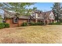 Charming two-story Tudor home with brick accents and well-manicured lawn at 2011 S Gray Dr, Lakewood, CO 80227