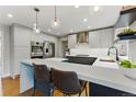 Modern kitchen features sleek white countertops, stainless steel appliances, and bar seating at 2011 S Gray Dr, Lakewood, CO 80227