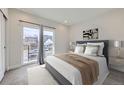 Bedroom features large window with balcony, modern decor and neutral color palette at 1462 Yates St, Denver, CO 80204