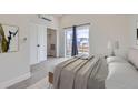 Light-filled bedroom with balcony access, large closet, and neutral carpeting at 1462 Yates St, Denver, CO 80204