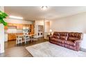 Spacious living area with an adjacent kitchen and laundry space, plus stylish wood flooring and neutral decor at 22920 E Roxbury Dr # H, Aurora, CO 80016