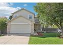 Charming two-story home with a manicured lawn and mature tree in a quiet neighborhood at 3982 S Himalaya Way, Aurora, CO 80013