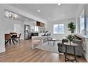 Bright, open-concept living room featuring hardwood floors and modern furnishings at 1150 S Yates St, Denver, CO 80219