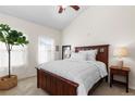 Cozy bedroom with a wooden bed frame, neutral tones, and natural light streaming through the windows at 9307 Amison Cir # 202, Parker, CO 80134