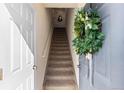 Inviting entryway featuring a staircase adorned with a decorative wreath on the front door at 9307 Amison Cir # 202, Parker, CO 80134