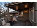 Relaxing covered deck with fire pit, seating, and views, perfect for outdoor entertaining and lounging at 5631 Silver Bluff Ct, Parker, CO 80134