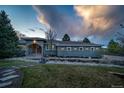 Beautiful exterior featuring a stone water feature, landscaped front yard, and charming architectural details at 5631 Silver Bluff Ct, Parker, CO 80134